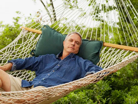 man-resting-in-a-hammock
