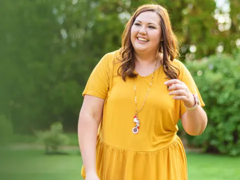 woman outside in yellow dress