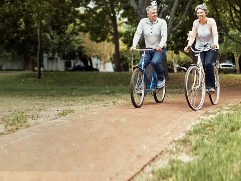 Old Couple Riding Bikes