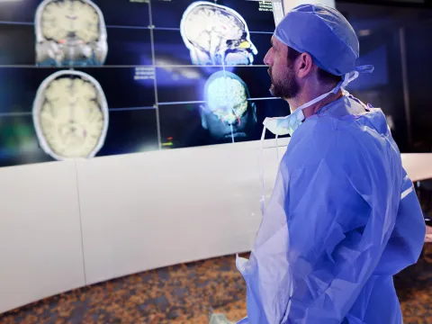 physician-looking-at-brain-scans