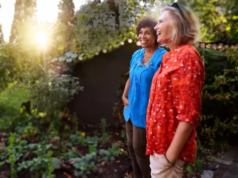Retirement-aged women standing in garden