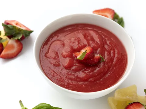 Bowl of strawberry sauce topping