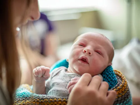 New mother holder her newborn baby.