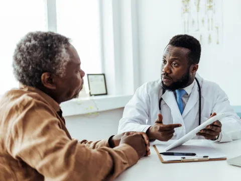 Older man talking with his doctor