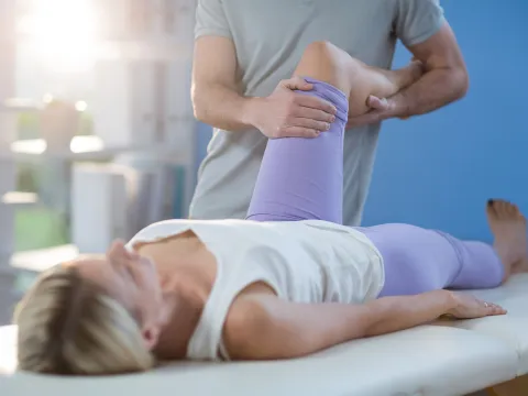 Physical Therapist Performing Stretch