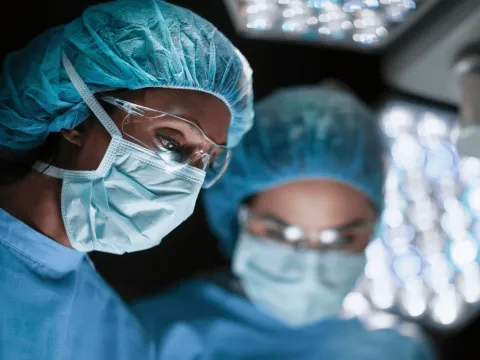Plastic Surgeons performing an operation.