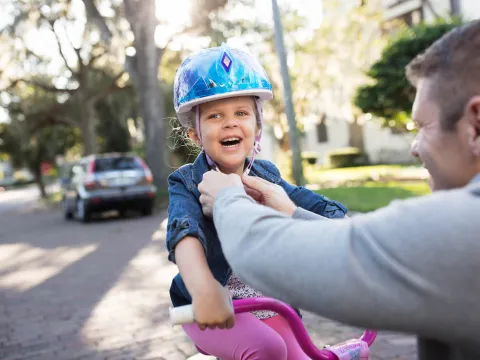 Dad taking his daughter on a bike ride.