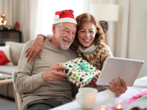 senior couple at home on a Christmas video call with the family