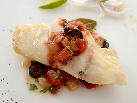Filet of fish topped with Catalan tomato sauce