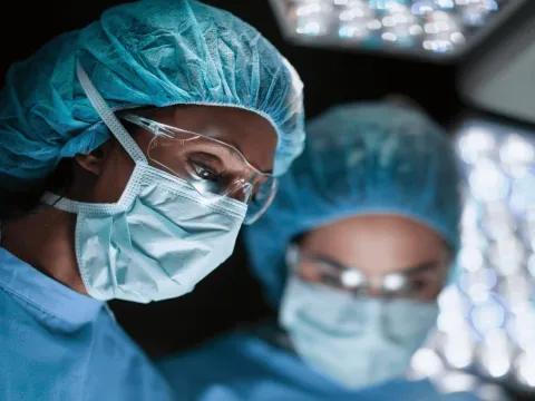 two surgeons performing an operation.