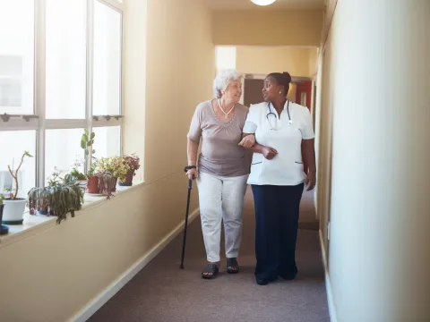 Physician walking with elderly patient