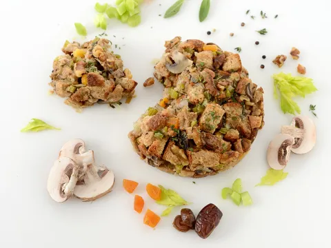 a large pile of stuffing, surrounded by mushrooms and dried fruit