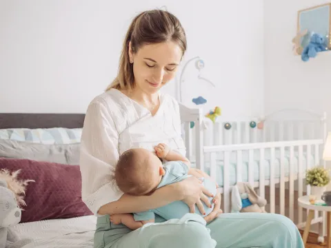A woman breastfeeding her infant.