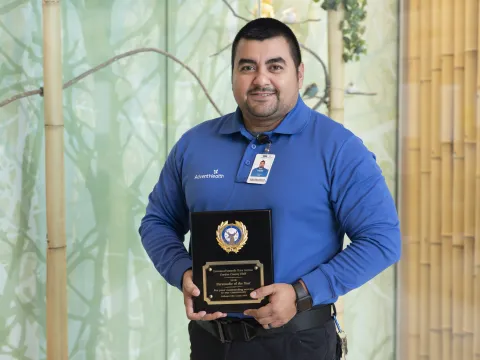 Victor Guzman holding an award.