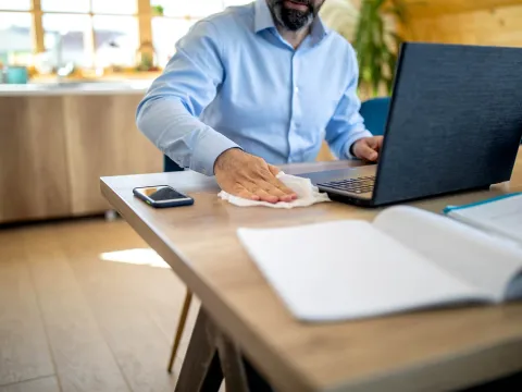 A man wiping down his work station.