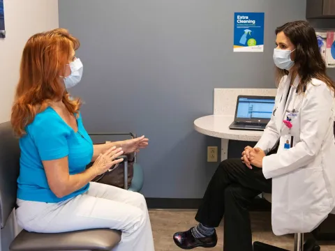 A patient discussing something to her doctor