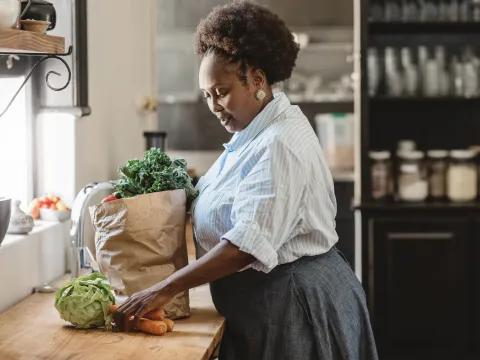 A woman unpacking her groceries.