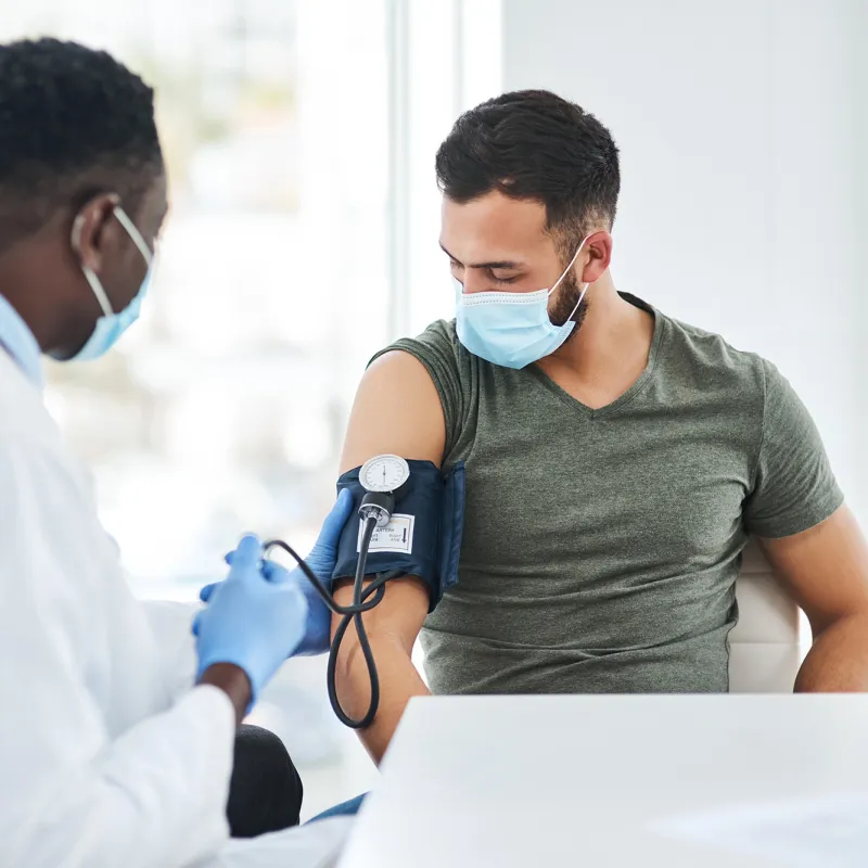 A Doctor Takes a Patient's Blood Pressure with a Blood Pressure Cuff