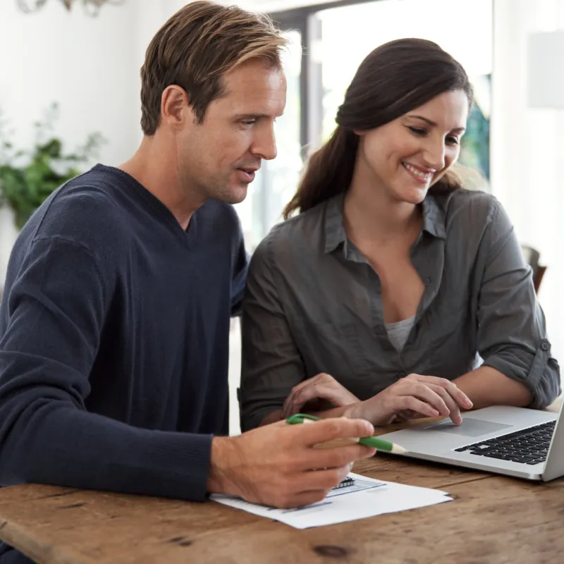 A couple making a list together at home.