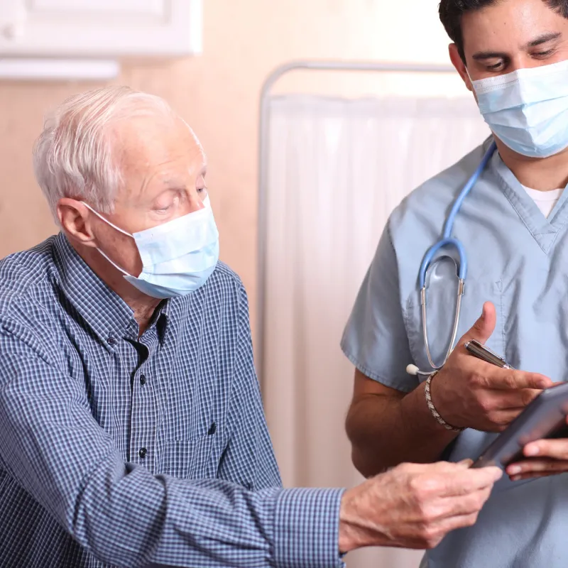 A man having a safe visit with his doctor. 