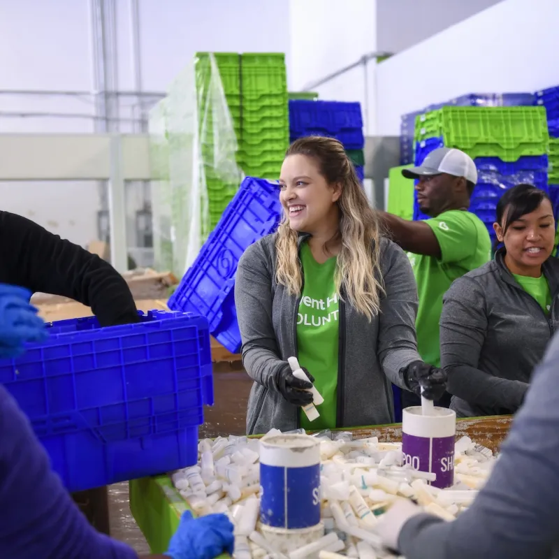 Volunteers sorting shampoo bottles