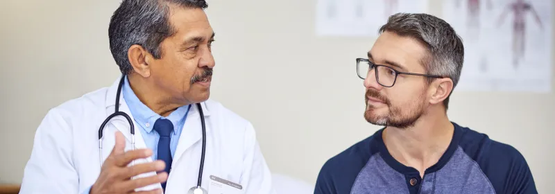 Man discussing his care with his PCP