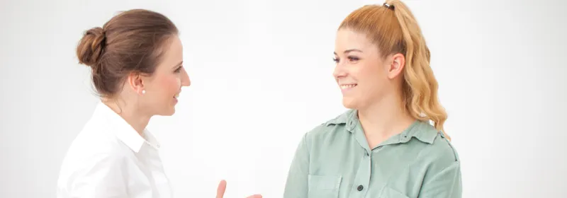 Woman discussing ongoing stomach pain with her doctor