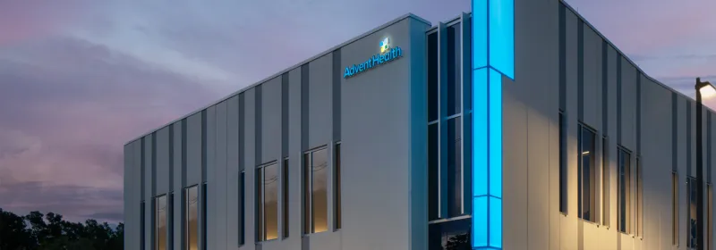 Outside of AdventHealth Care Pavilion Westchase at dusk.