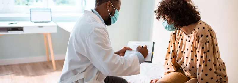Provider and patient wearing masks in an office