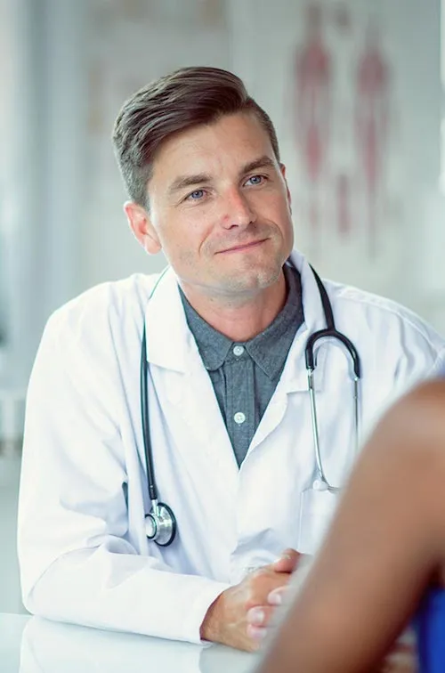 Doctor sitting at a table with a patient