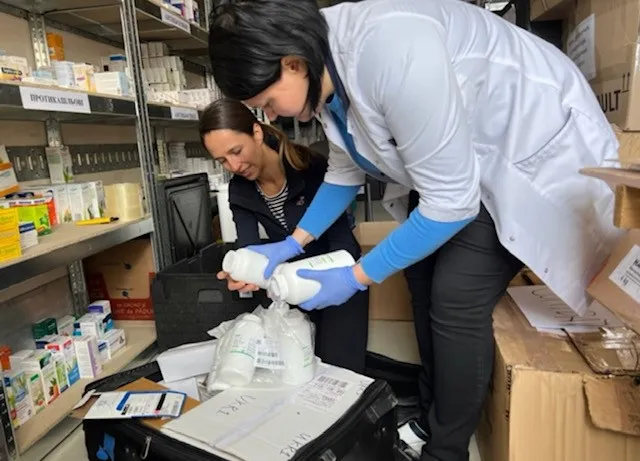 Dr. Natalia Sheshuryak and Julia Kostyuk in Ukraine with medication donated by AdventHealth Global Missions
