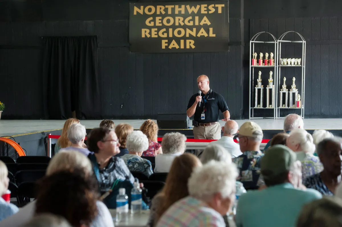 Doctor Land speaking in front of seniors at a public event