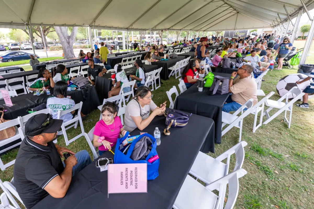 People under a banquet tent at the 2025 transplant reunion picnic